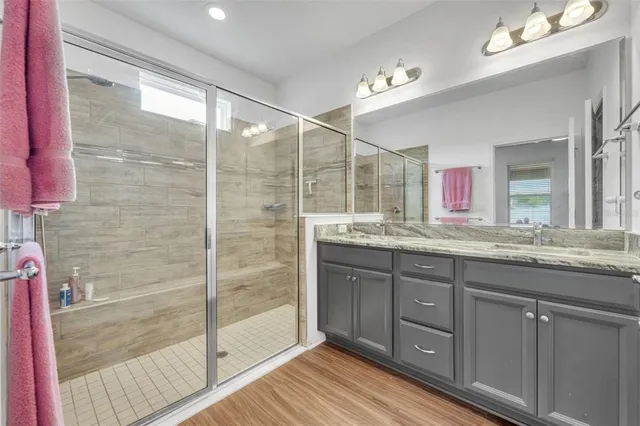a bathroom with a granite countertop sink mirror and double