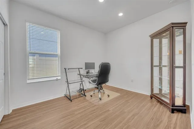 a view of a workspace with furniture and a window
