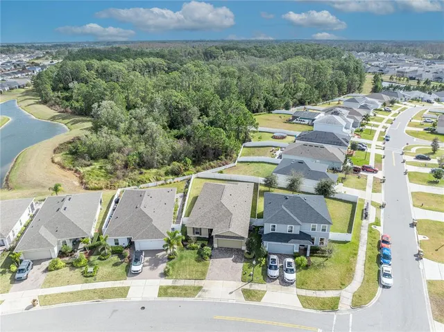 an aerial view of residential houses with outdoor space and swimming pool
