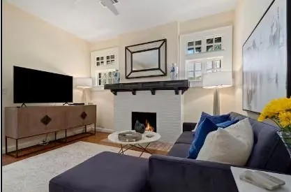 a living room with furniture and kitchen view