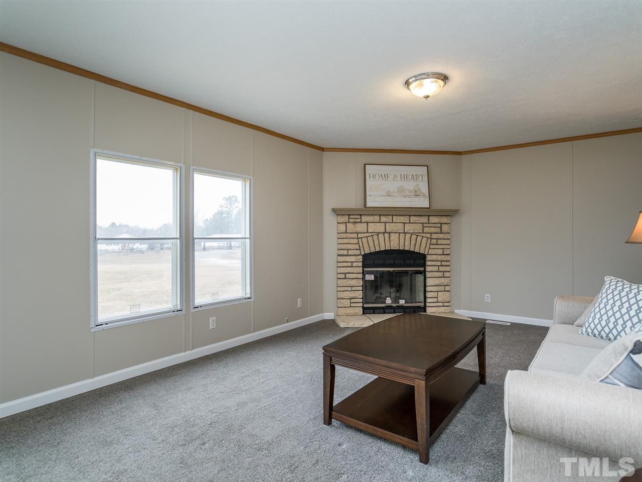 459 Nicholson Road Sanford, NC 27332 - Photo 14 of 28 The fireplace is the focal point in this inviting space.