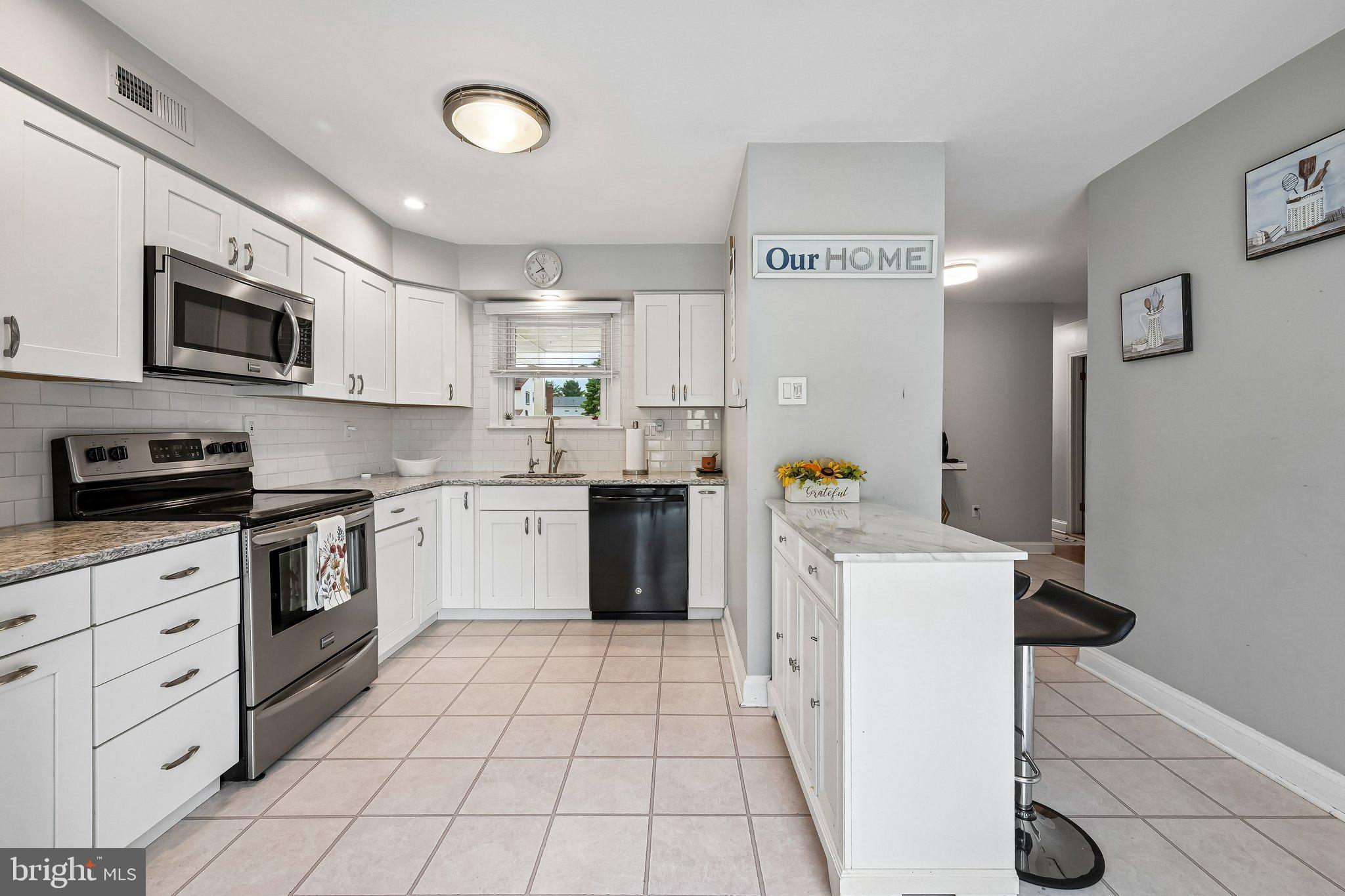 11 Old Mill Road Sewell, NJ 08080 - Photo 11 of 25 a kitchen with a stove a sink and a microwave