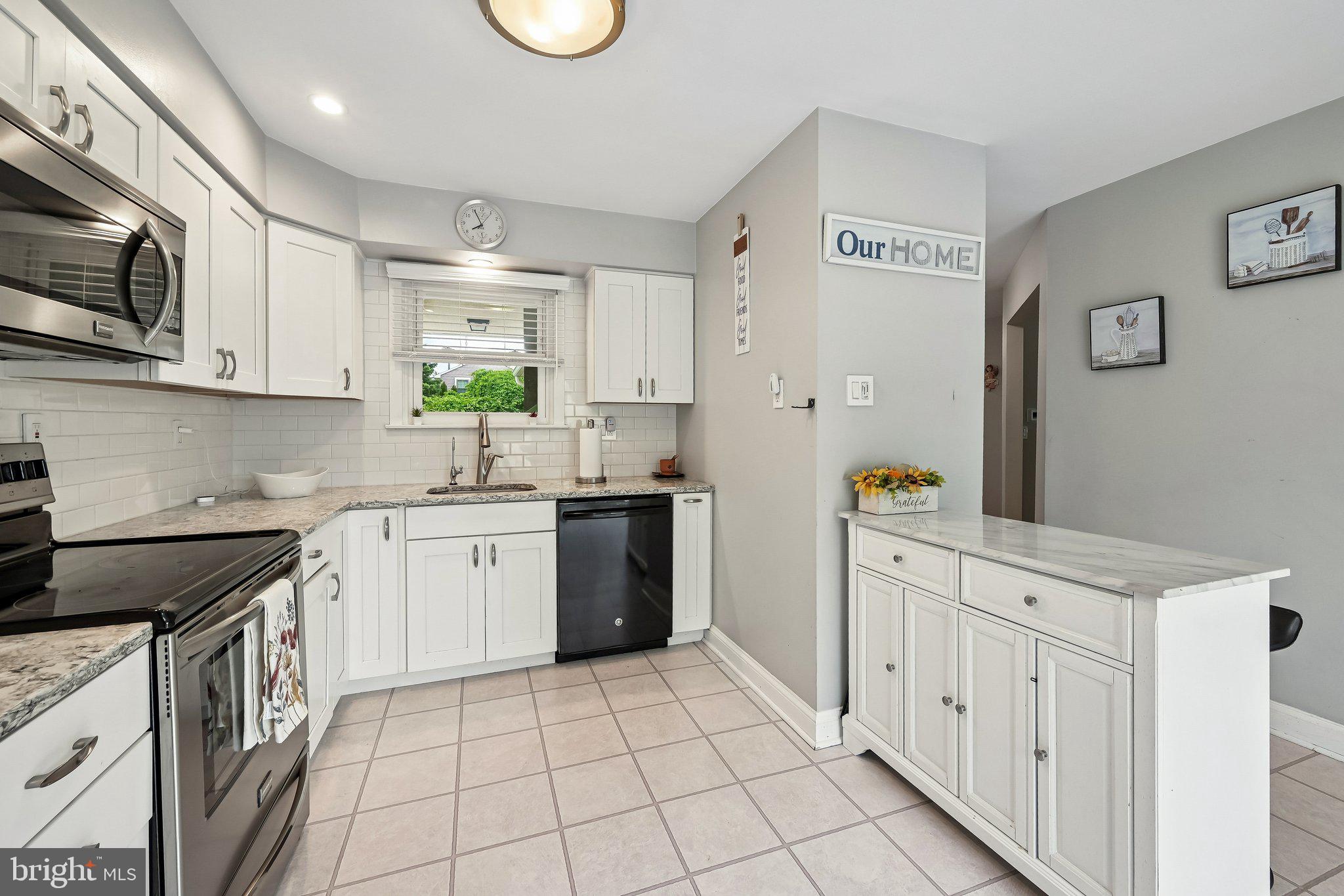 11 Old Mill Road Sewell, NJ 08080 - Photo 15 of 25 a kitchen with granite countertop a sink a stove top oven and cabinets