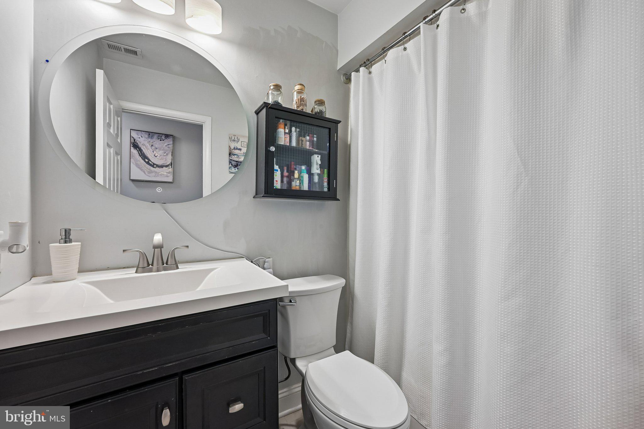 11 Old Mill Road Sewell, NJ 08080 - Photo 16 of 25 a bathroom with a sink a toilet and a mirror