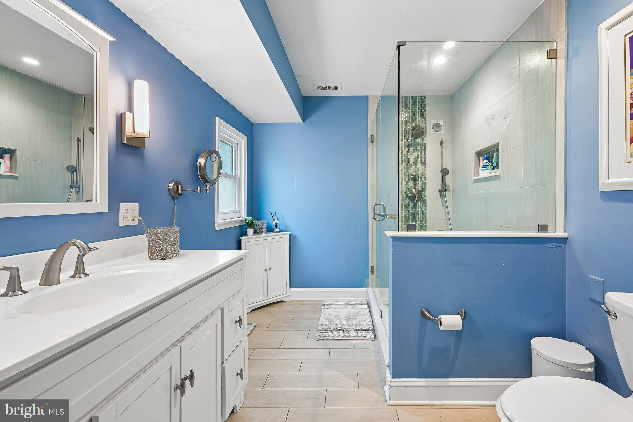11 Old Mill Road Sewell, NJ 08080 - Photo 20 of 25 a bathroom with a sink a toilet and mirror