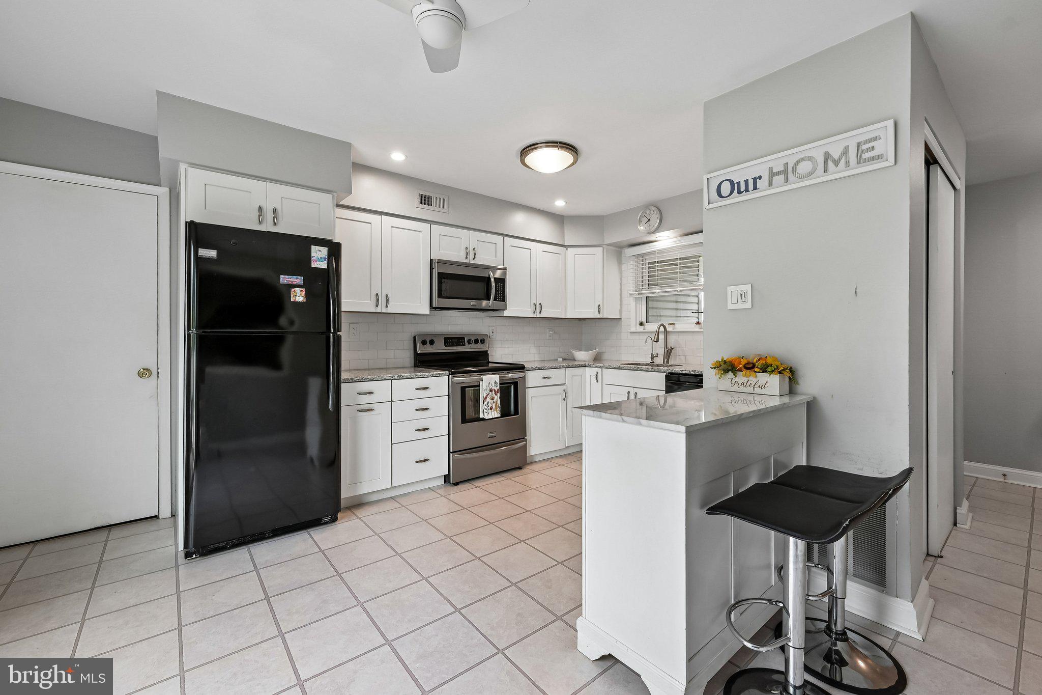 11 Old Mill Road Sewell, NJ 08080 - Photo 10 of 25 a kitchen with stainless steel appliances a refrigerator stove microwave and cabinets