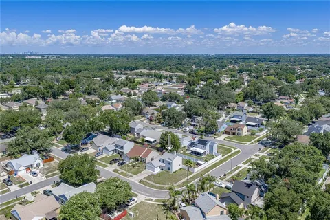 an aerial view of a residential houses with outdoor space and street view