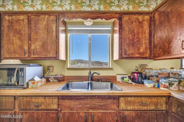 a view of a workspace with furniture and wooden floor