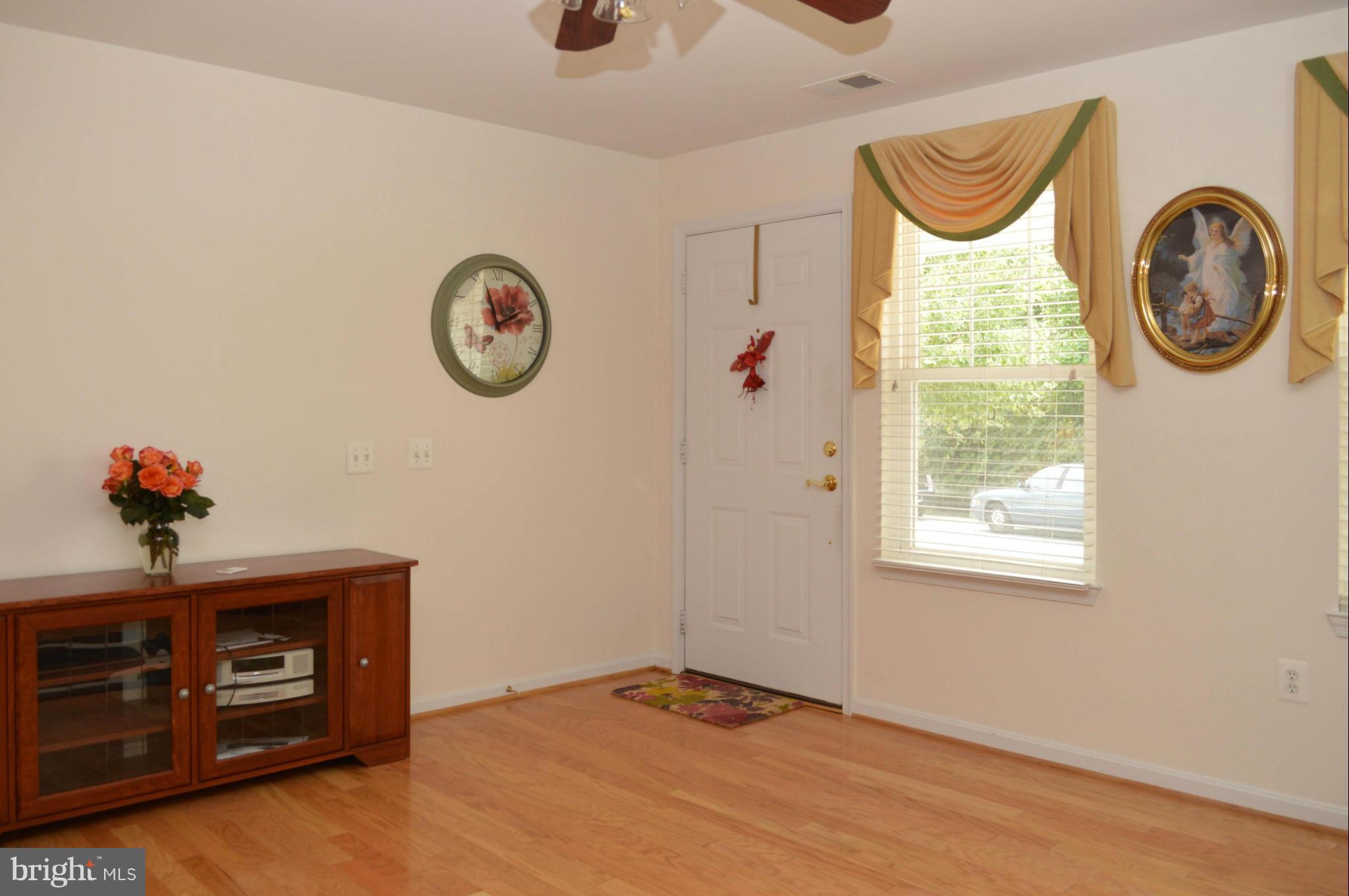 703 Merry Go Round Way Mount Airy, MD 21771 - Photo 4 of 27 a front view of a house with entryway wooden floor and a table