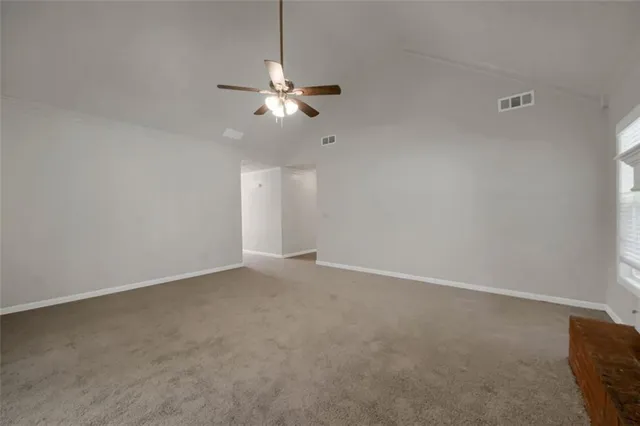 a view of an empty room with a fan