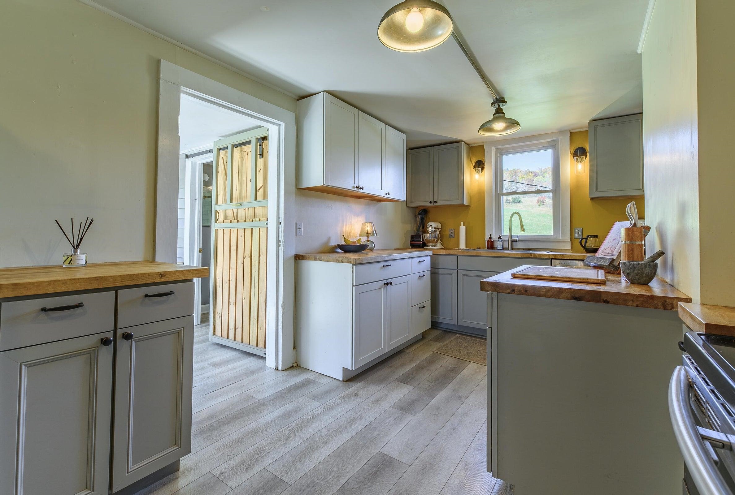 75 Margarets Lane Lexington, VA 24450 - Photo 25 of 55 a kitchen with a sink cabinets stainless steel appliances and a window