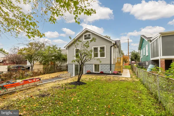 a front view of house with yard and trees around