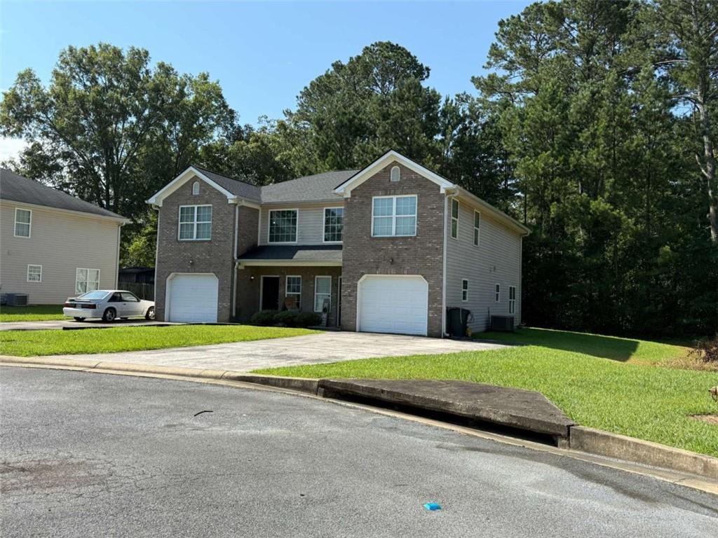 13-15 Crabapple Lane Northwest Rome, GA 30165 - Photo 3 of 3 a front view of a house with a yard and garage