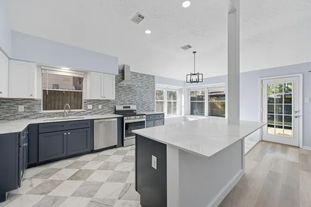 a kitchen with a sink stove and wooden cabinets
