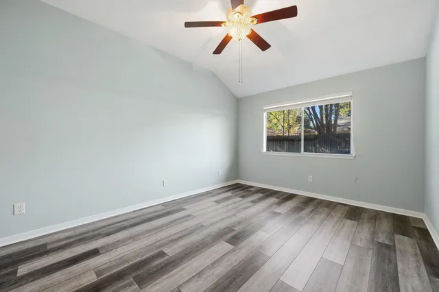wooden floor in an empty room with a window