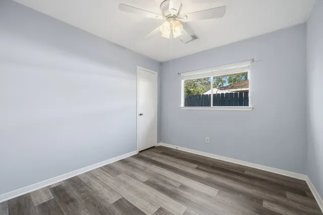 a view of room with window and ceiling fan