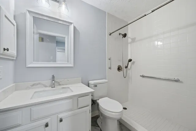 a bathroom with a sink toilet and shower