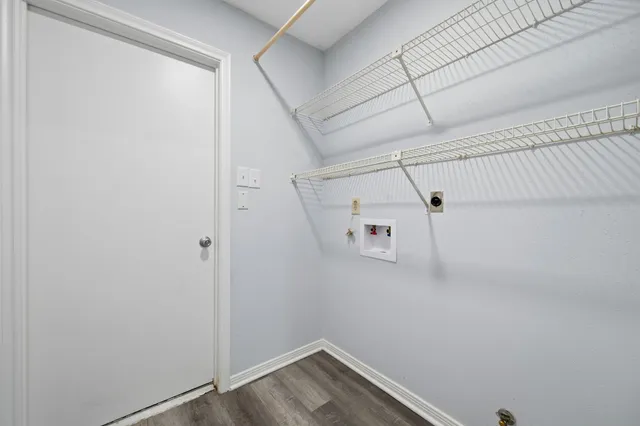 a view of storage and utility room with racks on the wall