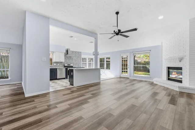 a view of a kitchen with furniture and wooden floor