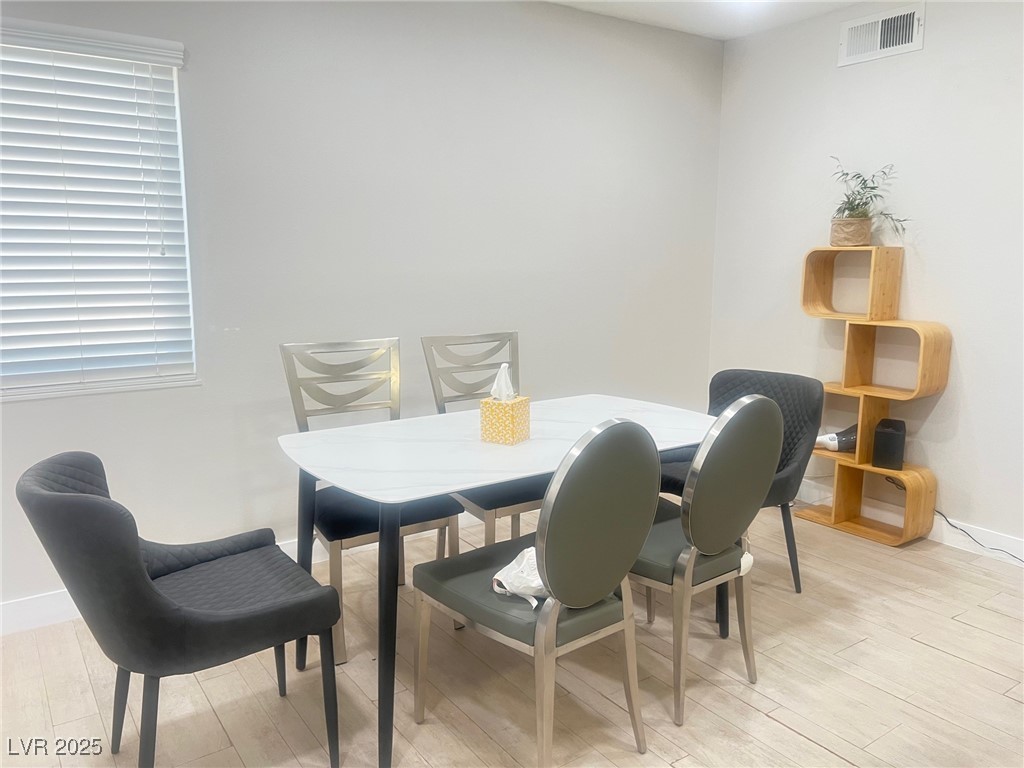 4194 Greenpoint Street Las Vegas, NV 89147 - Photo 11 of 25 Dining room with baseboards and light wood-style flooring