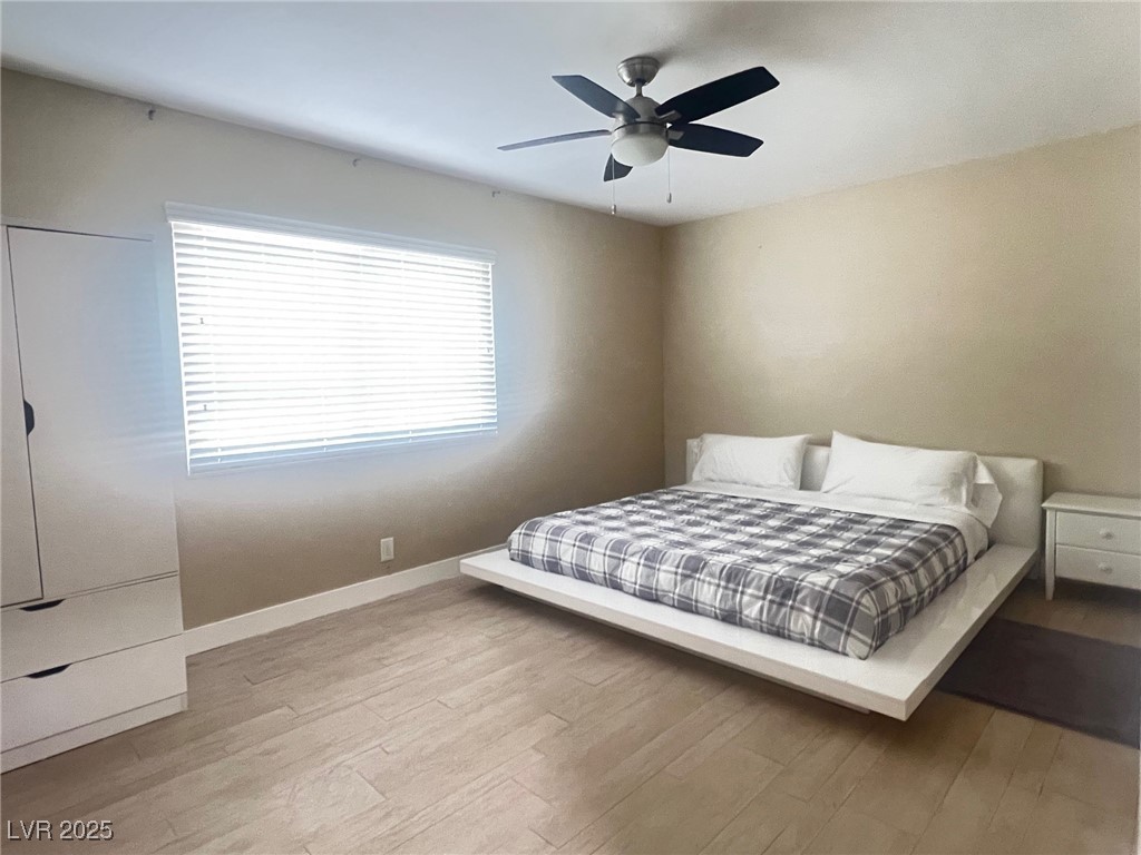 4194 Greenpoint Street Las Vegas, NV 89147 - Photo 13 of 25 Bedroom featuring light wood-type flooring and ceiling fan
