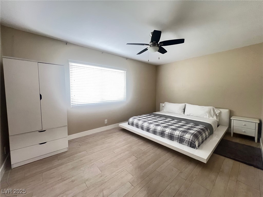 4194 Greenpoint Street Las Vegas, NV 89147 - Photo 14 of 25 Bedroom with light wood-style flooring and ceiling fan