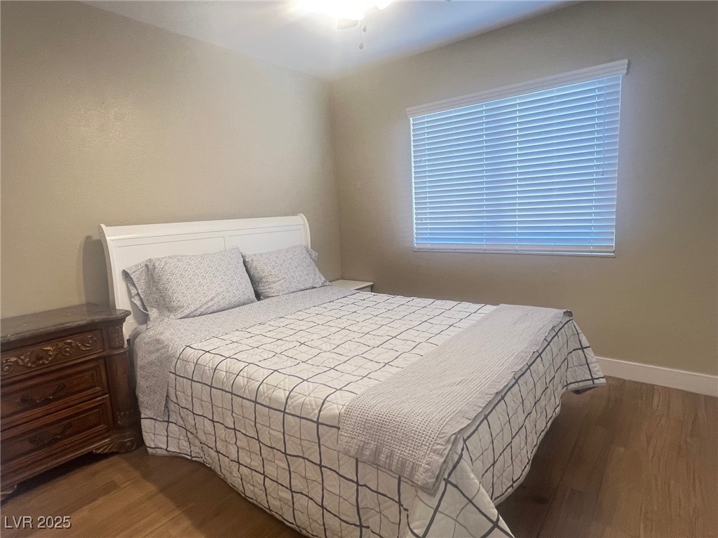 4194 Greenpoint Street Las Vegas, NV 89147 - Photo 16 of 25 Bedroom with dark wood-type flooring and a ceiling fan
