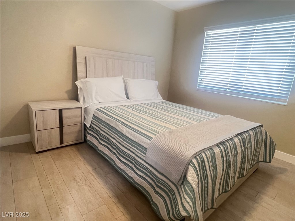 4194 Greenpoint Street Las Vegas, NV 89147 - Photo 17 of 25 Bedroom featuring baseboards and wood finished floors