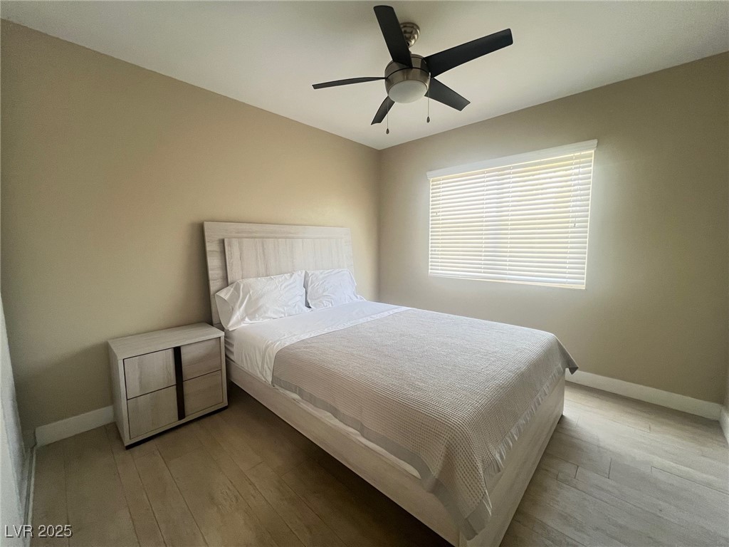 4194 Greenpoint Street Las Vegas, NV 89147 - Photo 19 of 25 Bedroom featuring hardwood / wood-style flooring and a ceiling fan