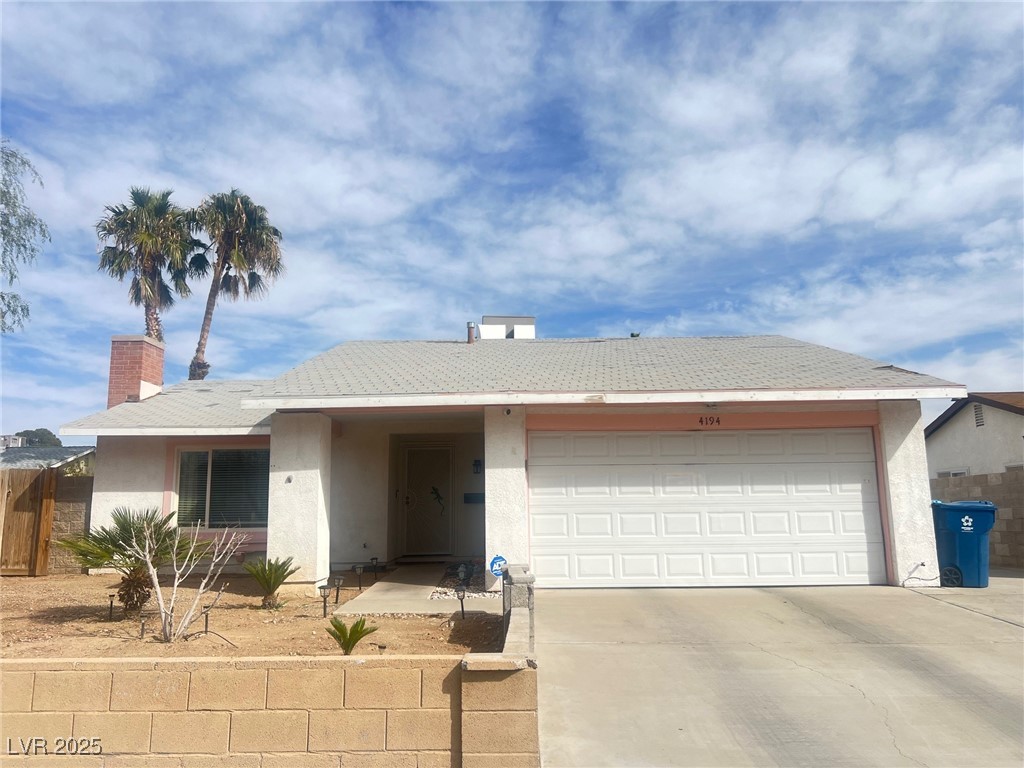 4194 Greenpoint Street Las Vegas, NV 89147 - Photo 2 of 25 Ranch-style home with stucco siding, an attached garage, a chimney, and concrete driveway