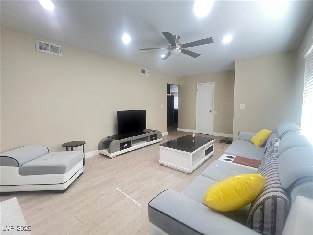4194 Greenpoint Street Las Vegas, NV 89147 - Photo 6 of 25 Living area with light wood finished floors and ceiling fan
