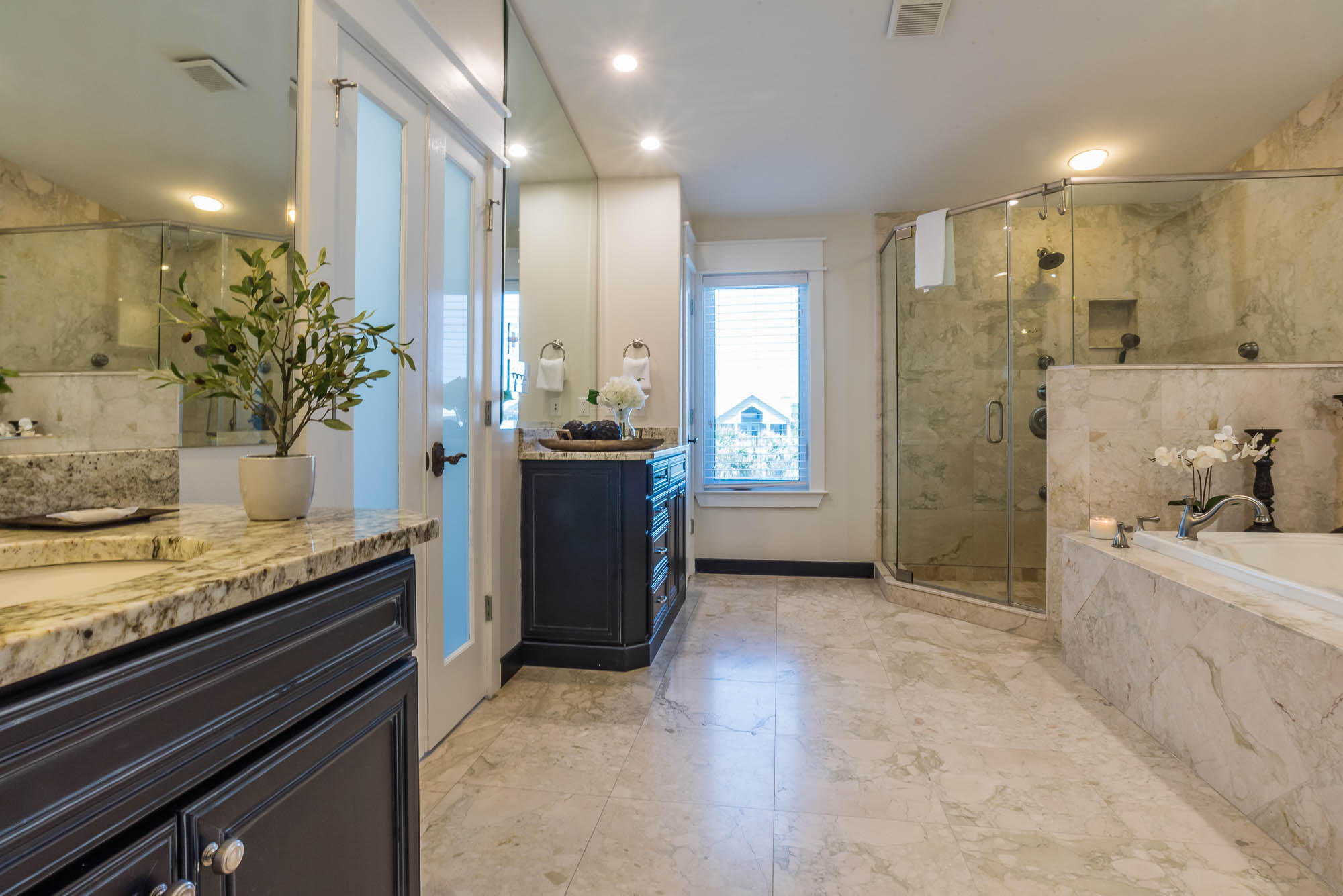 179 Pelican Circle Seacrest, FL 32461 - Photo 43 of 87 a spacious bathroom with a granite countertop sink a toilet a mirror and shower