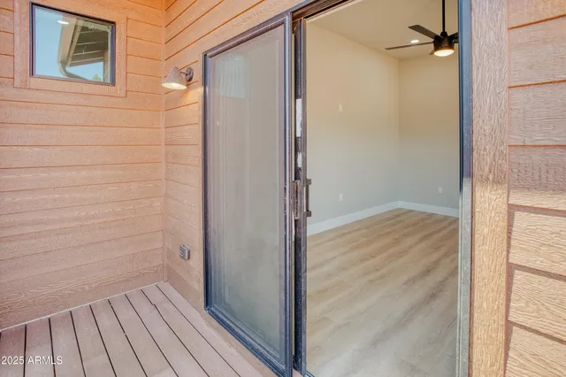 a view of walk in closet with wooden floor