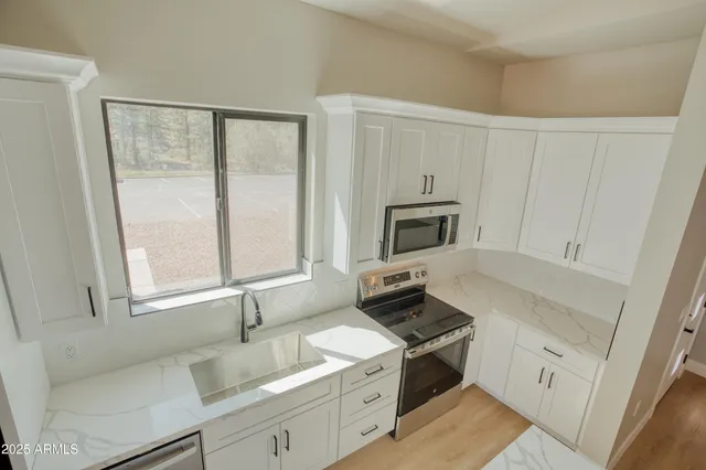 a kitchen with a sink stove and cabinets