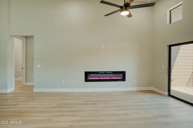 a view of a room with wooden floor and white walls