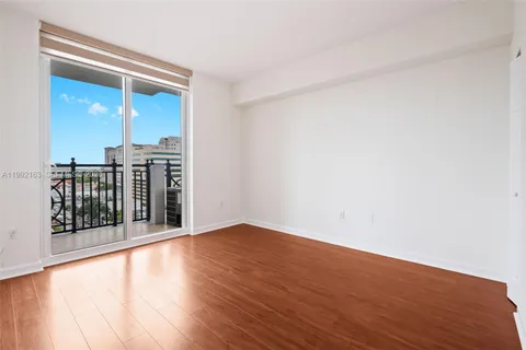 an empty room with wooden floor and closet