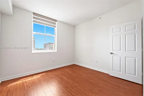 a bathroom with a toilet a sink and glass door