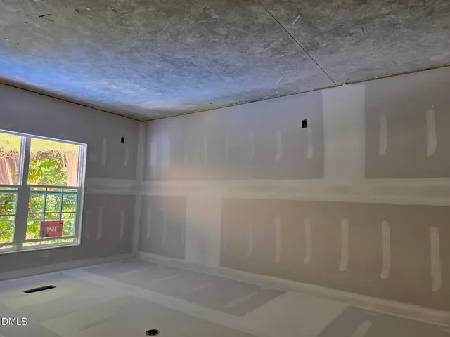 an empty room with windows and closet