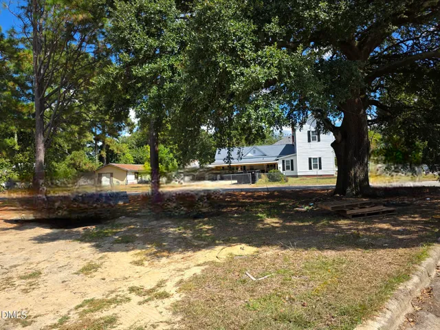 a view of a house with snow on the road