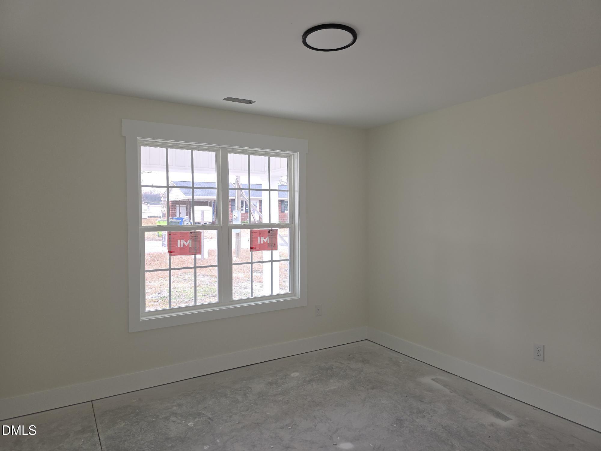 307 East Holmes Street Benson, NC 27504 - Photo 10 of 15 an empty room with a window