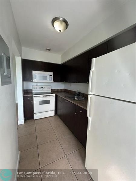 7421 Venetian Street, Unit 2 Miramar, FL 33023 - Photo 4 of 12 a kitchen with a cabinets and a stove