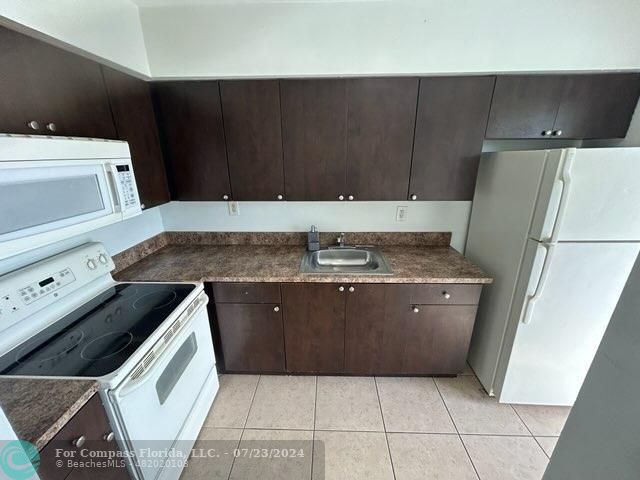 7421 Venetian Street, Unit 2 Miramar, FL 33023 - Photo 5 of 12 a kitchen with a cabinets and steel appliances