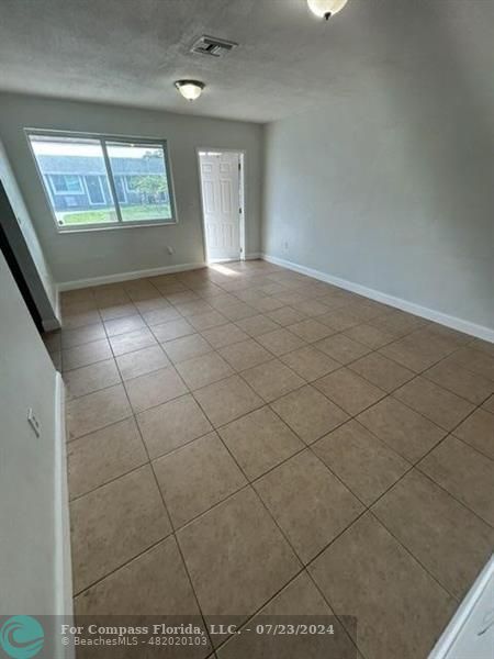 7421 Venetian Street, Unit 2 Miramar, FL 33023 - Photo 6 of 12 a view of an empty room and window
