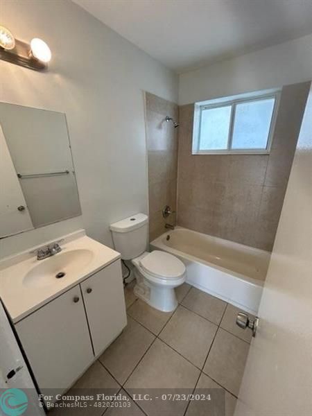 7421 Venetian Street, Unit 2 Miramar, FL 33023 - Photo 7 of 12 a bathroom with a toilet sink and mirror