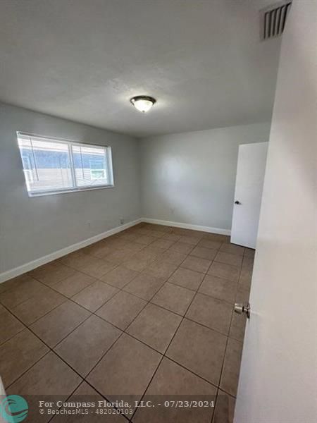 7421 Venetian Street, Unit 2 Miramar, FL 33023 - Photo 8 of 12 an empty room with windows