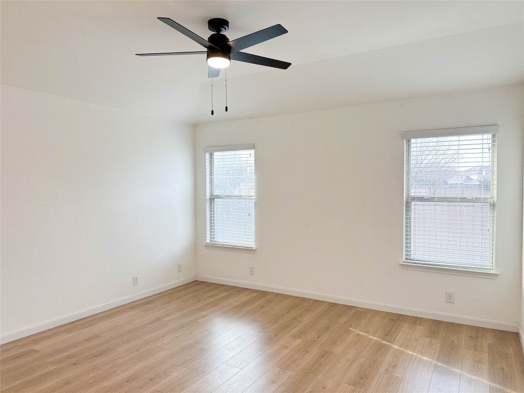 1437 April Meadows Loop Georgetown, TX 78626 - Photo 14 of 27 an empty room with a window and a fan