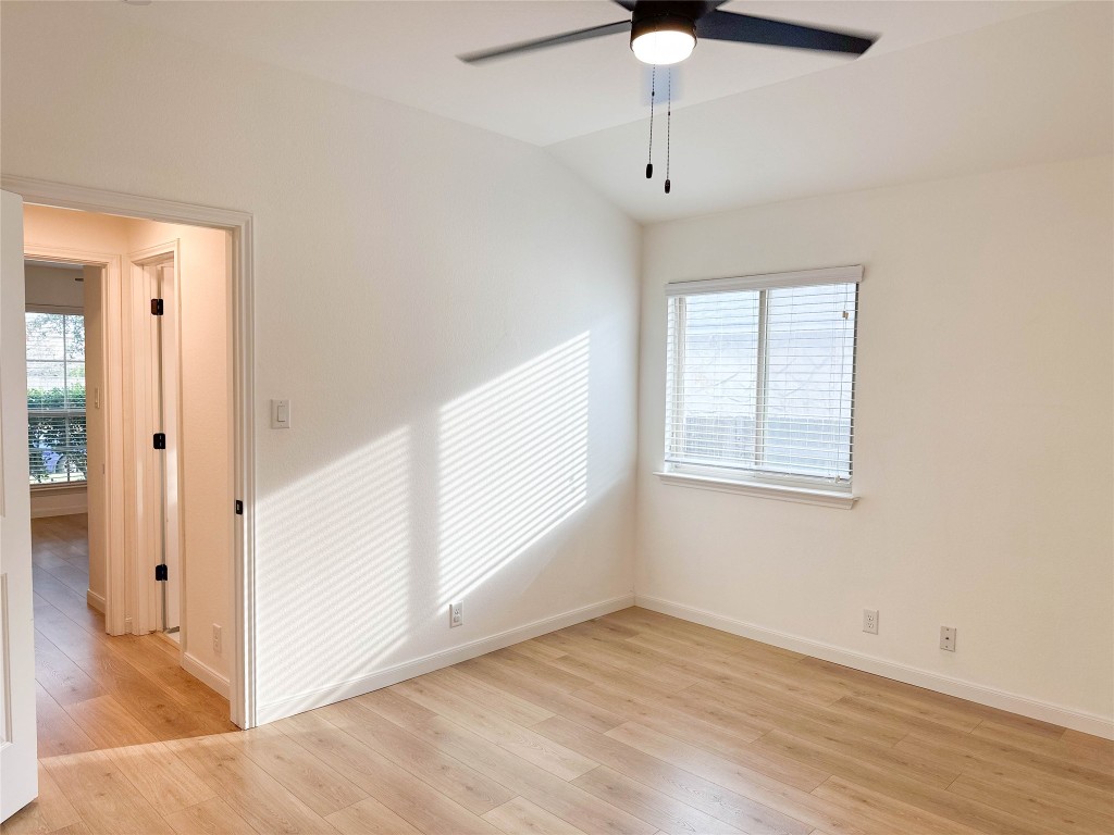 1437 April Meadows Loop Georgetown, TX 78626 - Photo 19 of 27 wooden floor in an empty room with a window