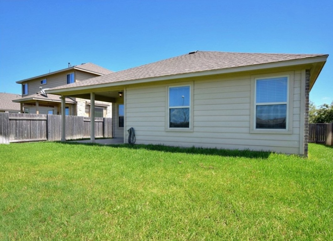1437 April Meadows Loop Georgetown, TX 78626 - Photo 21 of 27 a view of a house with a backyard