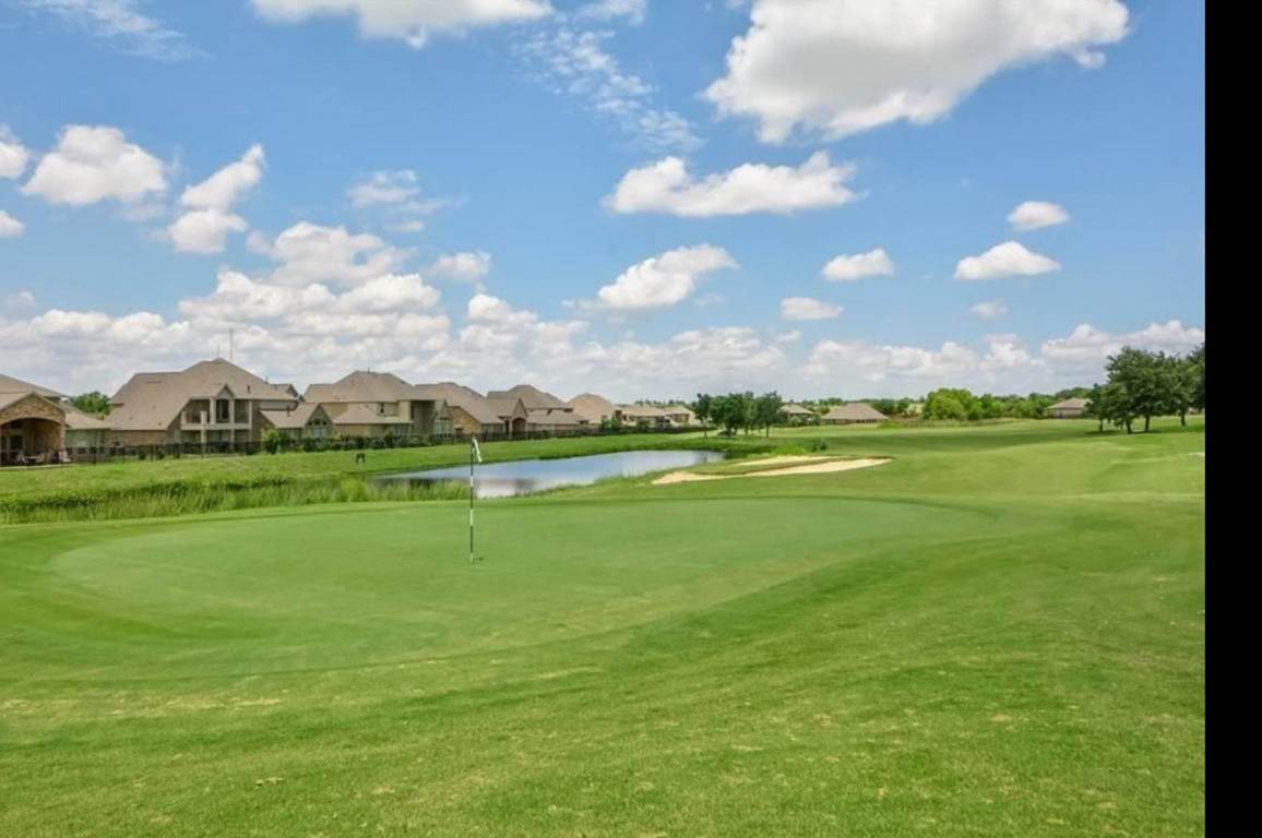 1437 April Meadows Loop Georgetown, TX 78626 - Photo 25 of 27 a view of a golf course with a lake