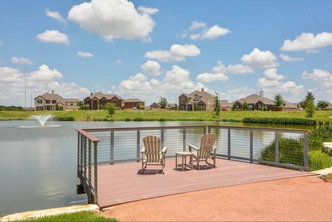 1437 April Meadows Loop Georgetown, TX 78626 - Photo 27 of 27 a view of a lake with a patio